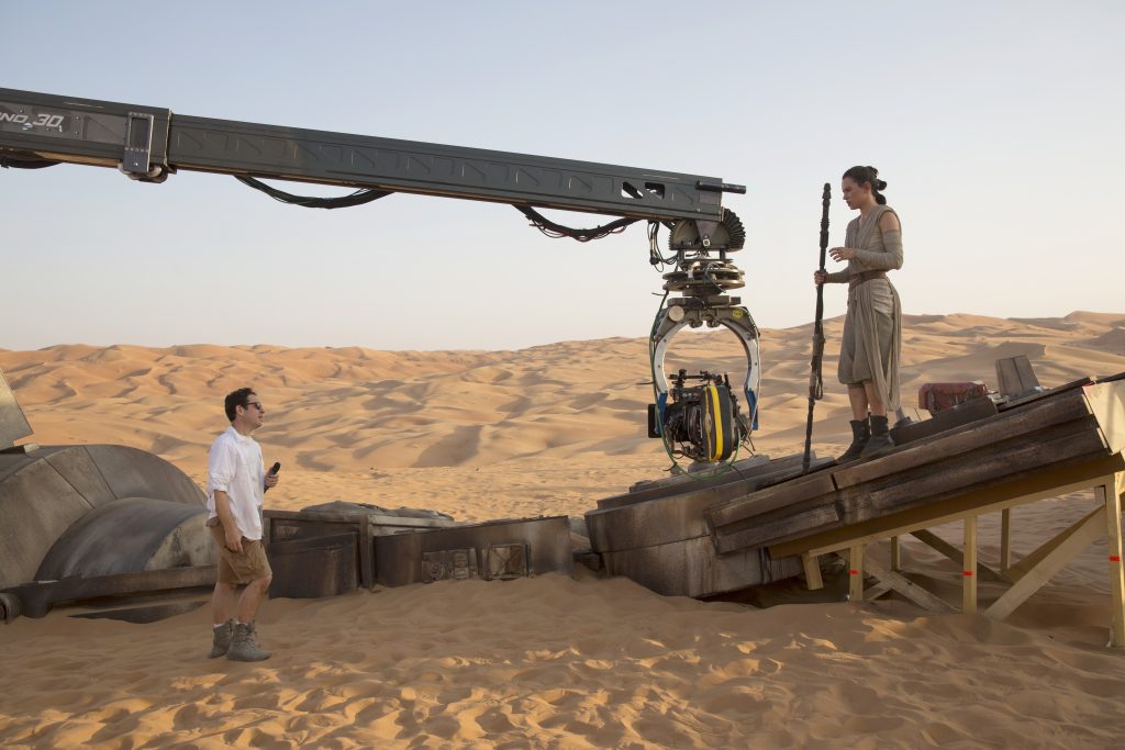 Star Wars: The Force Awakens..L to R: Director J.J. Abrams w/ actress Daisy Ridley (Rey) on set...Ph: David James..? 2015 Lucasfilm Ltd. & TM. All Right Reserved.
